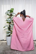 Woman wearing pink linen boubou dress by Selaro Luxury Wears