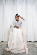 Cream sheer kaftan with butterfly embroidery and wide sleeves styled with gold accessories.”